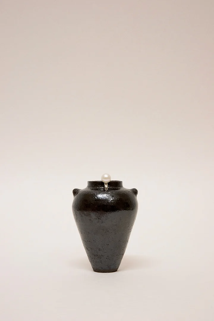 Artisanal handmade wheel-thrown ceramic vase tableware set. Dark Glaze ceramics. Hand built vessel with white pearl silver earrings.